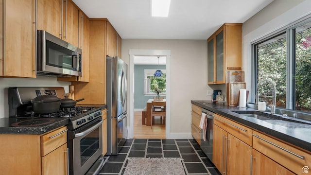 2504 S Dearborn St E, Salt Lake City, UT 84106 - kitchen with appliances with stainless steel finishes, a sink, glass insert cabinets, baseboards, and brown cabinetry