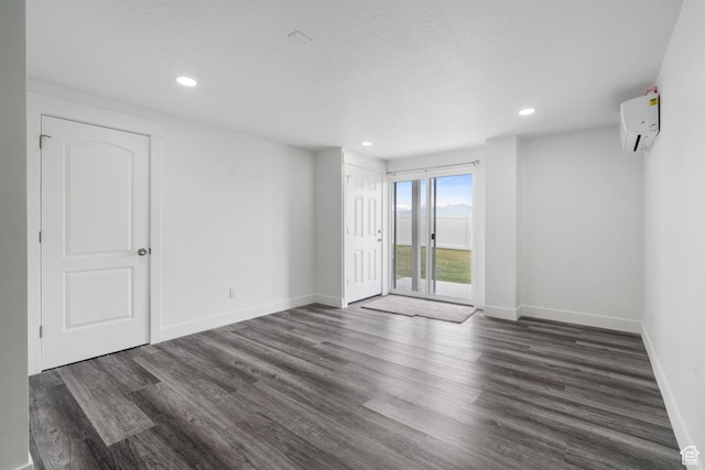 2092 N Red Yearling Dr, Saratoga Springs, UT 84045 - unfurnished room with a wall mounted AC, dark wood-style flooring, baseboards, and recessed lighting