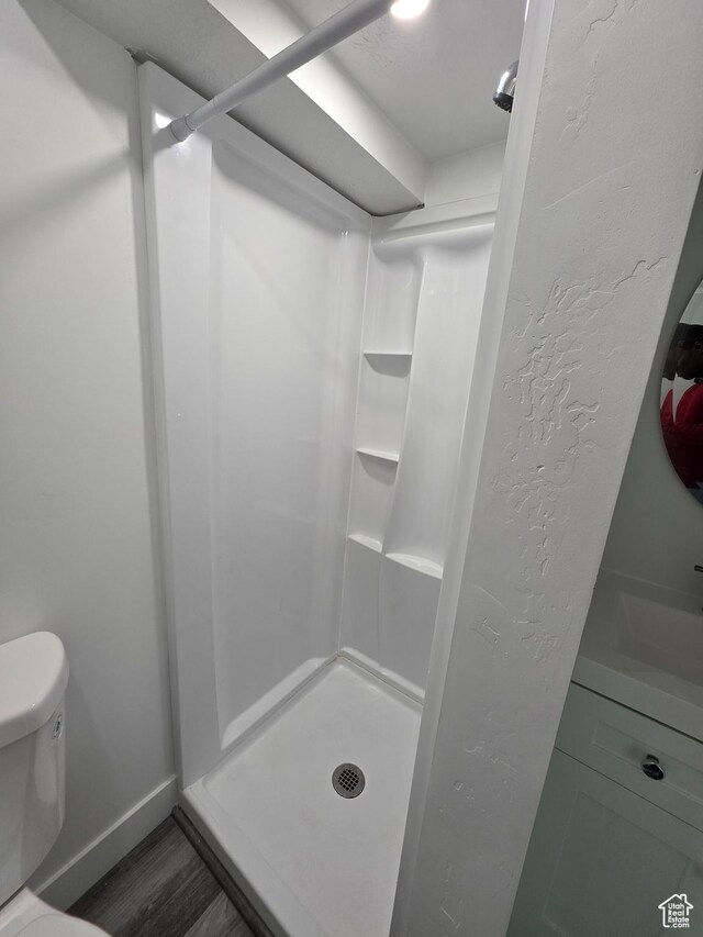 2092 N Red Yearling Dr, Saratoga Springs, UT 84045 - bathroom with a stall shower, toilet, baseboards, and wood finished floors