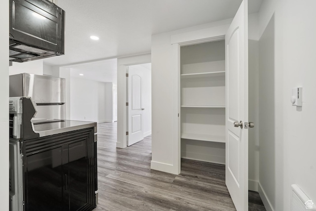 2092 N Red Yearling Dr, Saratoga Springs, UT 84045 - kitchen with wood finished floors, baseboards, black microwave, and recessed lighting