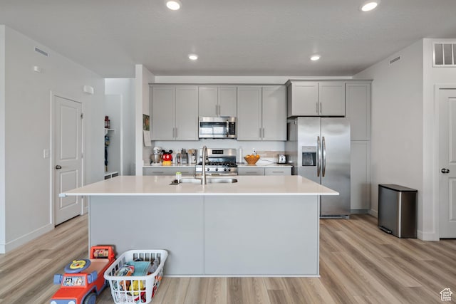 2092 N Red Yearling Dr, Saratoga Springs, UT 84045 - kitchen featuring stainless steel appliances, a sink, gray cabinets, light countertops, and recessed lighting