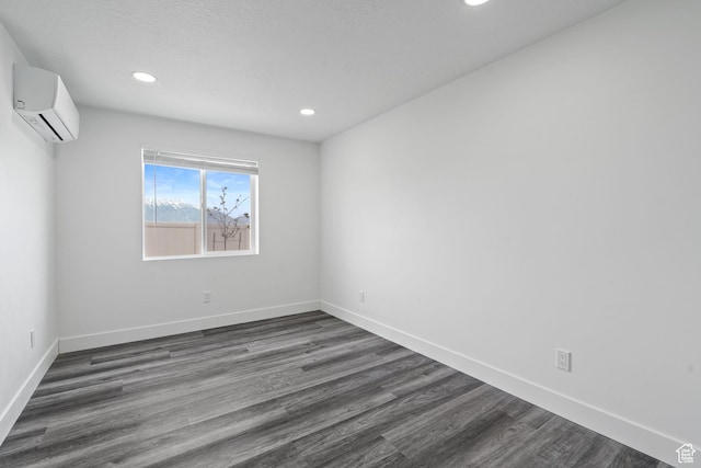 2092 N Red Yearling Dr, Saratoga Springs, UT 84045 - spare room with a wall mounted air conditioner, recessed lighting, dark wood-type flooring, and baseboards