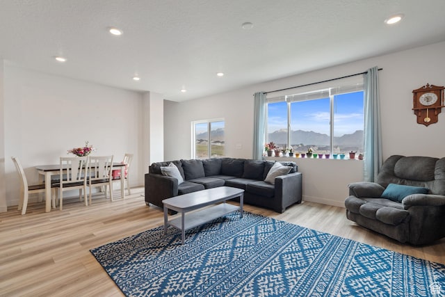 2092 N Red Yearling Dr, Saratoga Springs, UT 84045 - living area featuring light wood-type flooring, a mountain view, recessed lighting, and baseboards