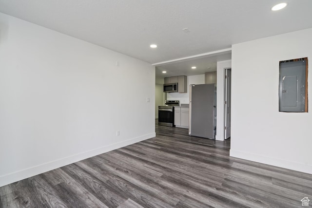 2092 N Red Yearling Dr, Saratoga Springs, UT 84045 - unfurnished living room featuring electric panel, dark wood-type flooring, recessed lighting, and baseboards