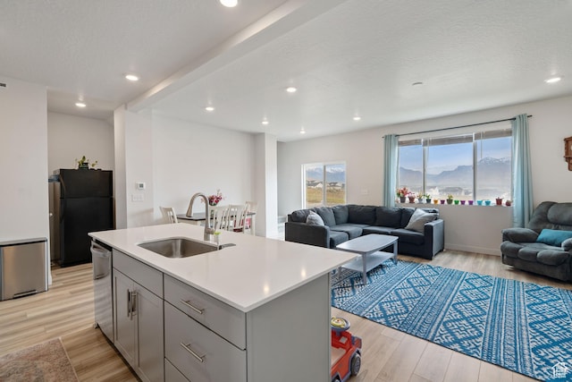 2092 N Red Yearling Dr, Saratoga Springs, UT 84045 - kitchen featuring a sink, freestanding refrigerator, open floor plan, dishwasher, and gray cabinetry