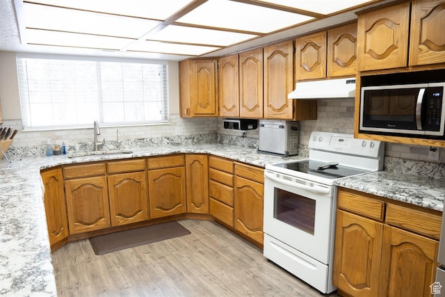 731 Pioneer Dr, Soda Springs, ID 83276 - kitchen featuring white electric range oven, under cabinet range hood, stainless steel microwave, a sink, and backsplash