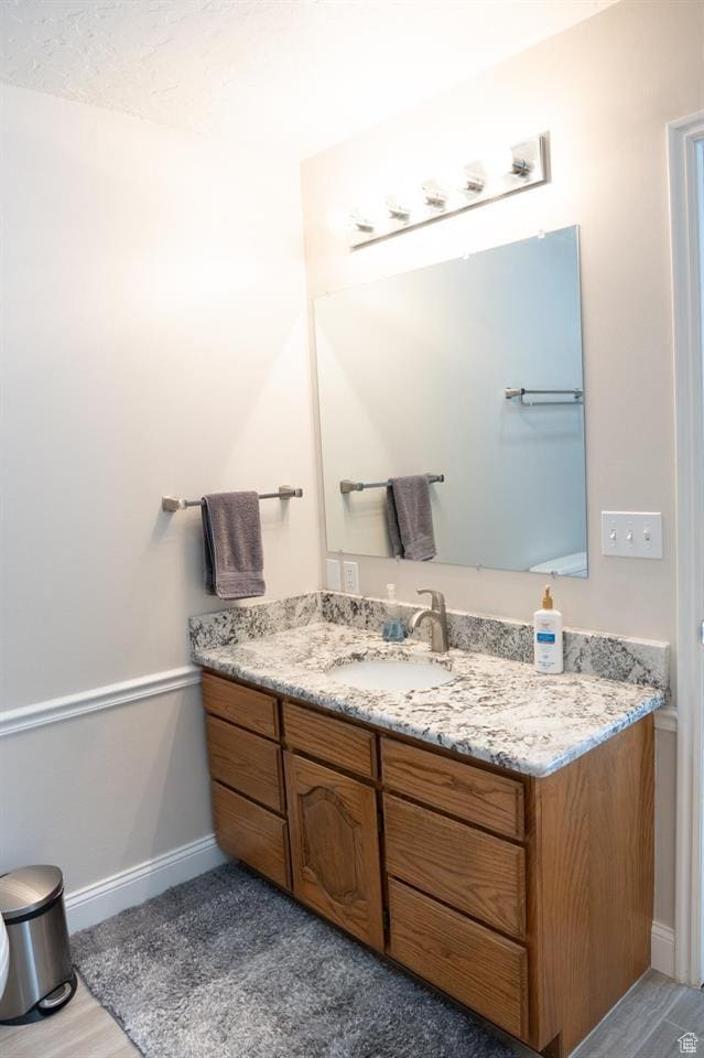 731 Pioneer Dr, Soda Springs, ID 83276 - bathroom with vanity, baseboards, and wood finished floors