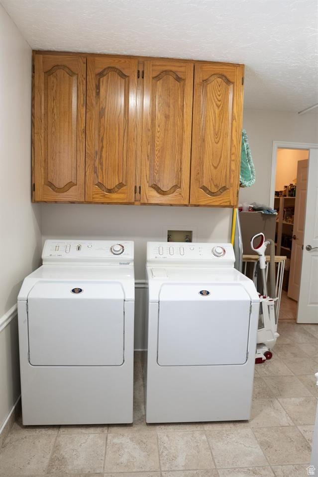 731 Pioneer Dr, Soda Springs, ID 83276 - washroom with washing machine and dryer, cabinet space, baseboards, and a textured ceiling