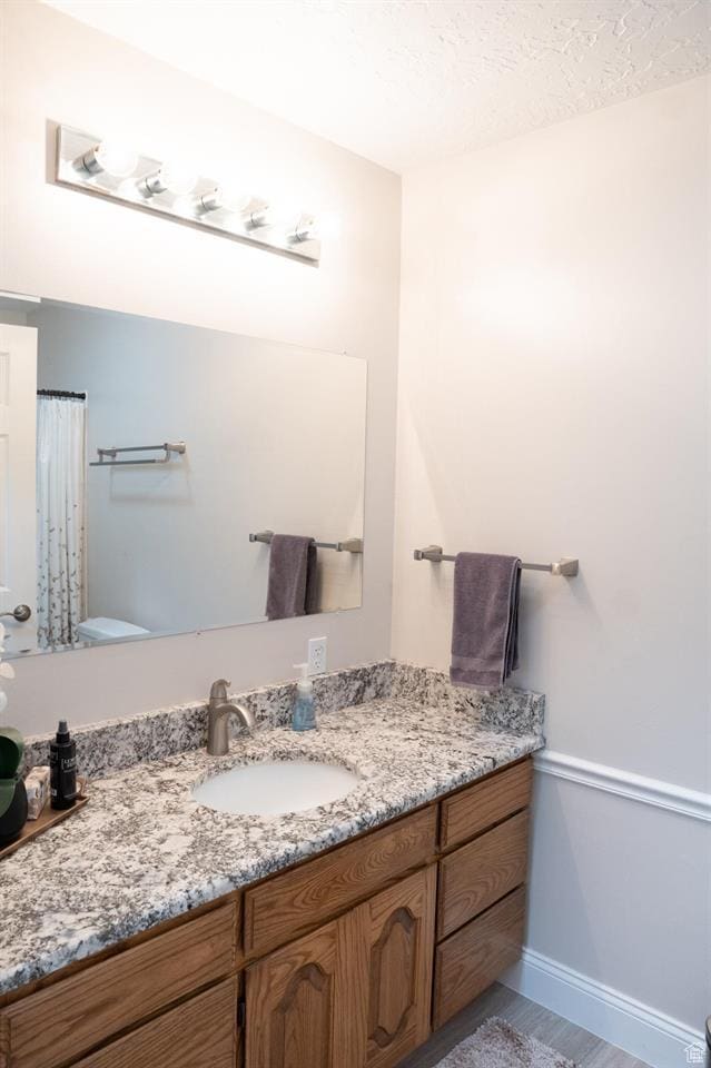 731 Pioneer Dr, Soda Springs, ID 83276 - bathroom with toilet, vanity, and baseboards