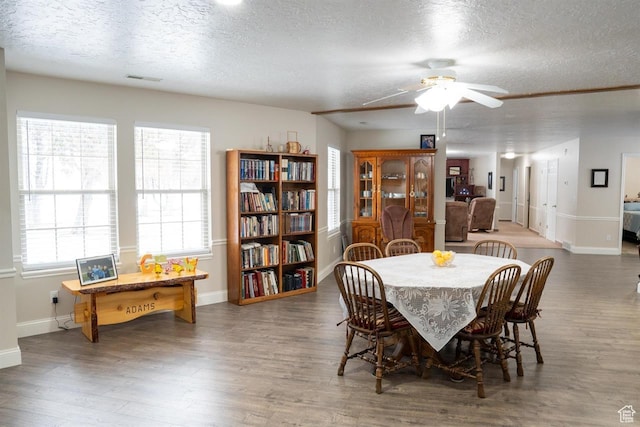 731 Pioneer Dr, Soda Springs, ID 83276 - dining space with a textured ceiling, wood finished floors, a ceiling fan, and baseboards