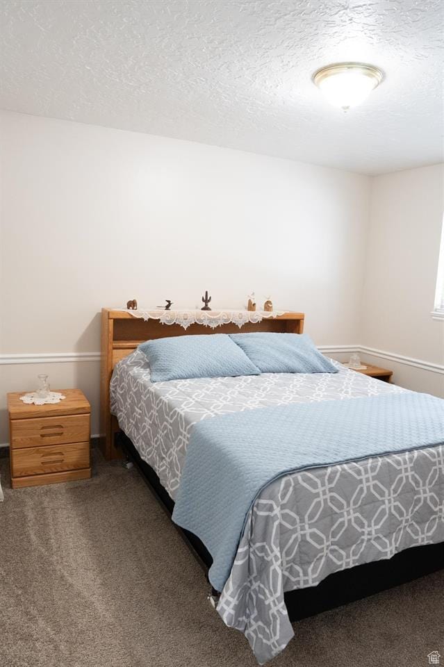 731 Pioneer Dr, Soda Springs, ID 83276 - carpeted bedroom with a textured ceiling and baseboards