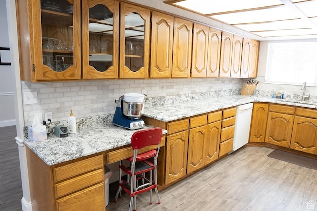 731 Pioneer Dr, Soda Springs, ID 83276 - kitchen featuring white dishwasher, a sink, backsplash, and light wood-style floors