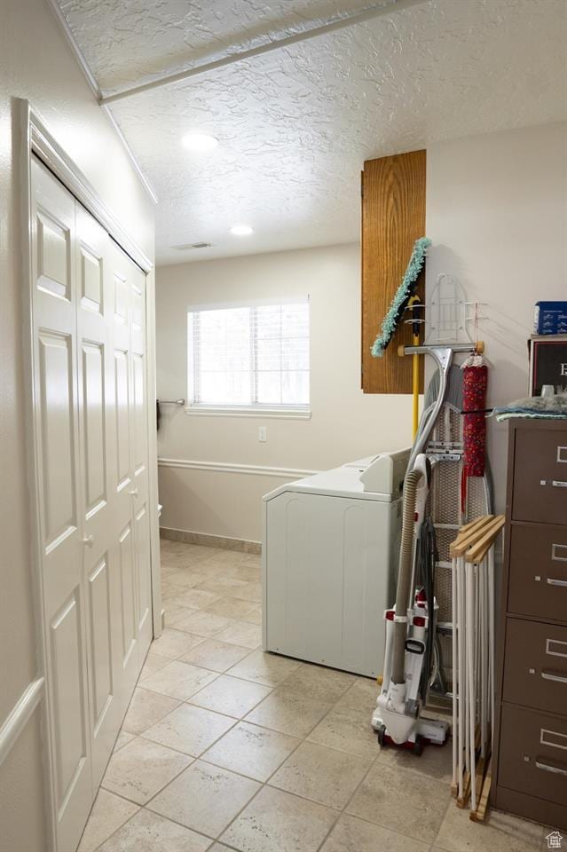 731 Pioneer Dr, Soda Springs, ID 83276 - laundry area with washer / clothes dryer, cabinet space, a textured ceiling, light tile patterned floors, and baseboards