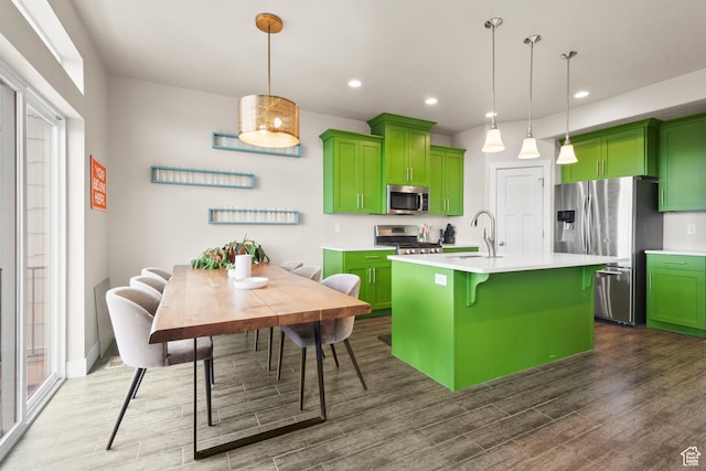 2335 W Cresthaven Ln, Lehi, UT 84043 - kitchen featuring green cabinets, appliances with stainless steel finishes, dark wood-style floors, light countertops, and a breakfast bar area