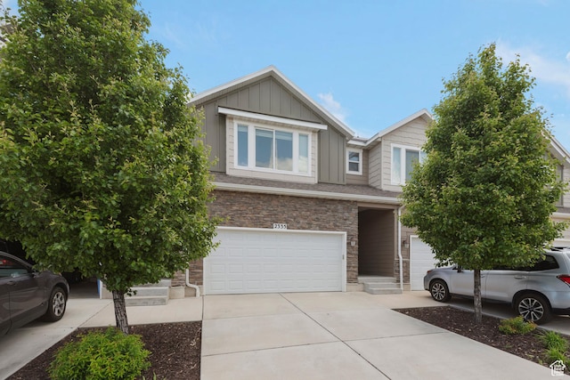 2335 W Cresthaven Ln, Lehi, UT 84043 - view of front of house featuring an attached garage, concrete driveway, stone siding, and board and batten siding