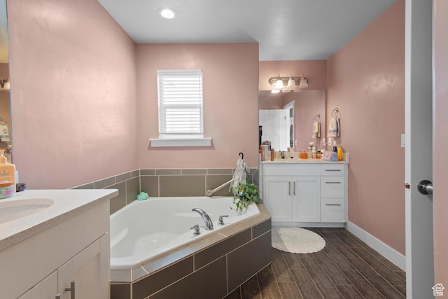 2335 W Cresthaven Ln, Lehi, UT 84043 - full bathroom with two vanities, a bath, wood finished floors, and baseboards