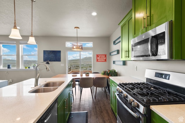 2335 W Cresthaven Ln, Lehi, UT 84043 - kitchen featuring green cabinetry, stainless steel appliances, a sink, dark wood-type flooring, and decorative light fixtures