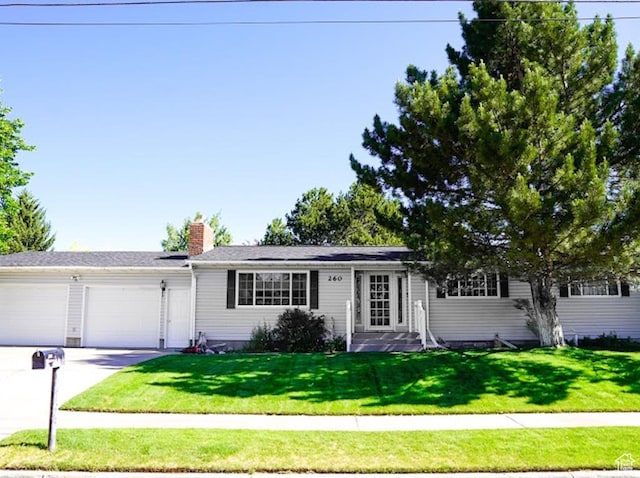 260 W 4th S, Soda Springs, ID 83276 - ranch-style house with a garage, a front lawn, driveway, and a chimney