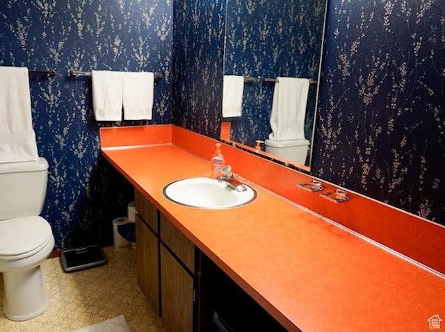 260 W 4th S, Soda Springs, ID 83276 - bathroom featuring toilet, wallpapered walls, vanity, and baseboards