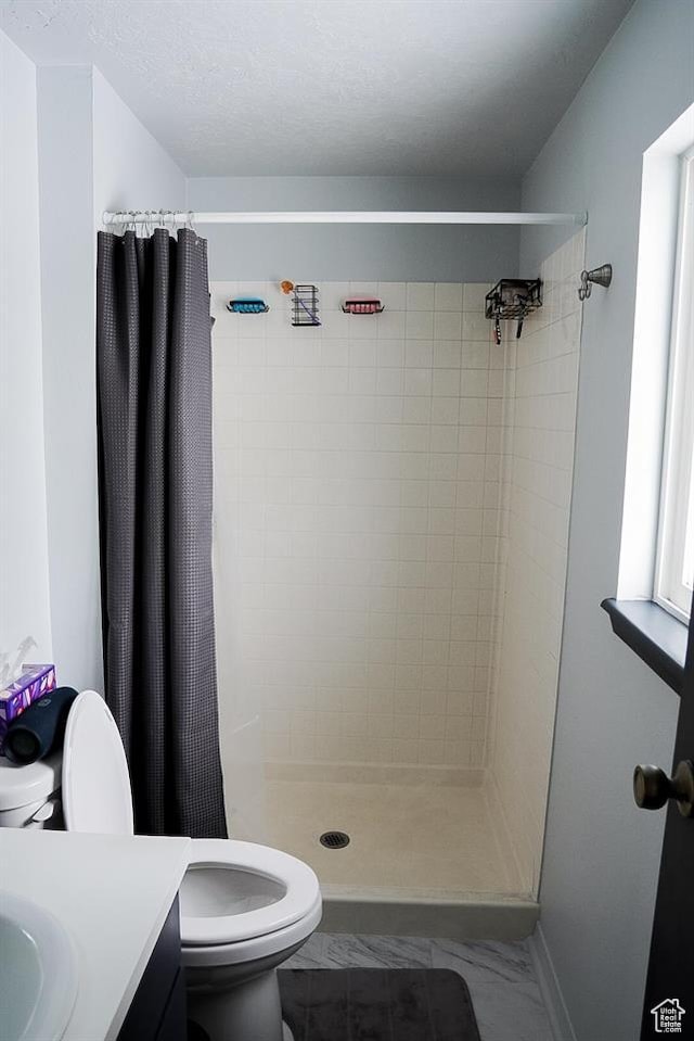260 W 4th S, Soda Springs, ID 83276 - bathroom featuring toilet, vanity, a shower stall, and baseboards