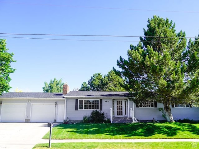 260 W 4th S, Soda Springs, ID 83276 - ranch-style house featuring an attached garage, concrete driveway, a front lawn, and a chimney