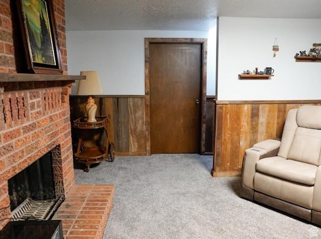 260 W 4th S, Soda Springs, ID 83276 - living area with wainscoting, wooden walls, a fireplace, carpet flooring, and a textured ceiling