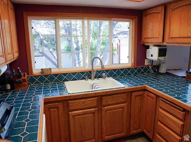 260 W 4th S, Soda Springs, ID 83276 - kitchen featuring tile countertops, a sink, and brown cabinetry