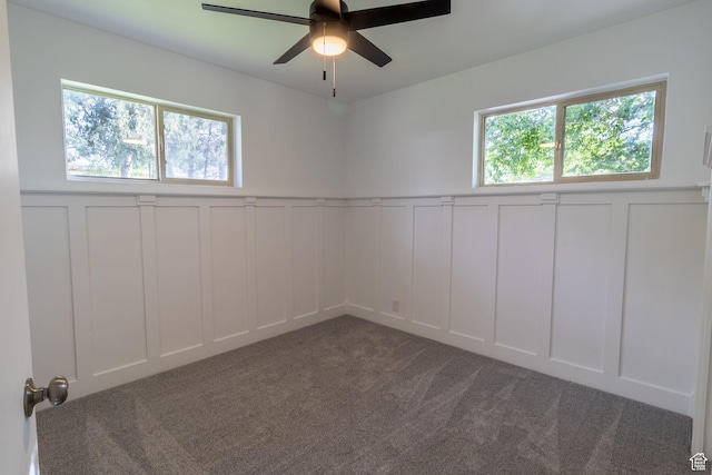 2079 W 3900 S, Roy, UT 84067 - unfurnished room with a decorative wall, a ceiling fan, wainscoting, and carpet flooring