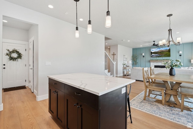 13321 S Split Oak Dr, Herriman, UT 84096 - kitchen featuring light wood-style floors, a chandelier, a kitchen island, open floor plan, and recessed lighting