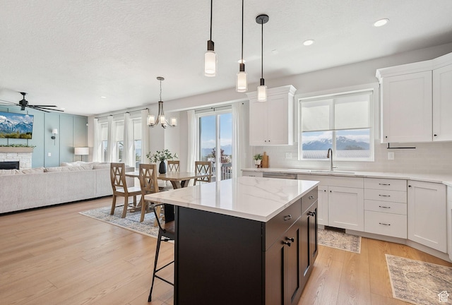 13321 S Split Oak Dr, Herriman, UT 84096 - kitchen featuring open floor plan, ceiling fan, tasteful backsplash, white cabinets, and recessed lighting