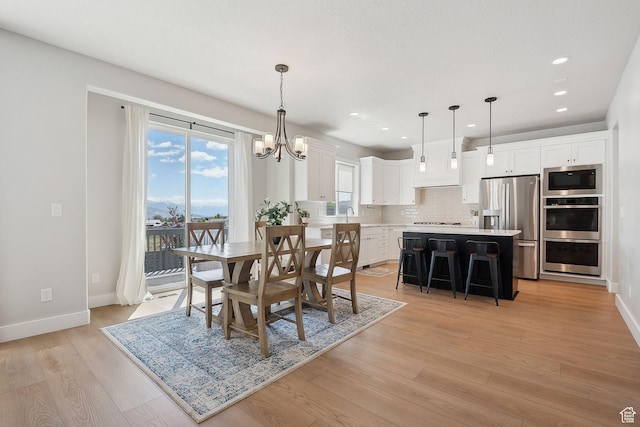 13321 S Split Oak Dr, Herriman, UT 84096 - dining room with a chandelier, light wood finished floors, baseboards, and recessed lighting