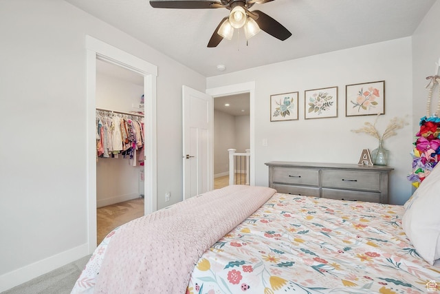 13321 S Split Oak Dr, Herriman, UT 84096 - bedroom with a spacious closet, baseboards, a closet, carpet floors, and a ceiling fan