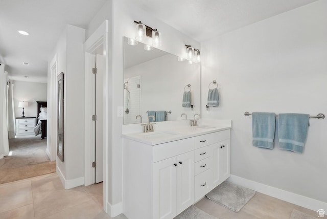 13321 S Split Oak Dr, Herriman, UT 84096 - ensuite bathroom with double vanity, tile patterned floors, baseboards, and a shower