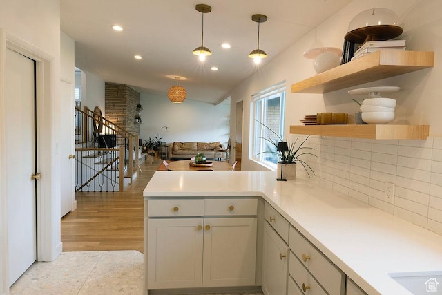 5466 S Woodcrest Dr, Holladay, UT 84117 - kitchen with a peninsula, recessed lighting, light countertops, backsplash, and hanging light fixtures