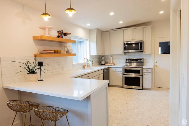 5466 S Woodcrest Dr, Holladay, UT 84117 - kitchen with appliances with stainless steel finishes, a peninsula, a kitchen breakfast bar, tasteful backsplash, and recessed lighting