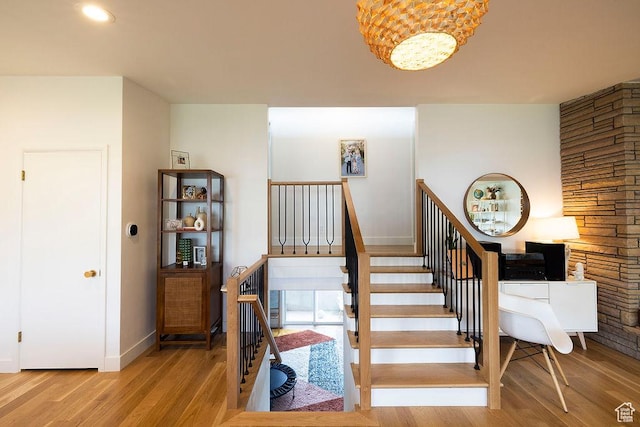 5466 S Woodcrest Dr, Holladay, UT 84117 - stairway featuring wood finished floors, baseboards, and a chandelier