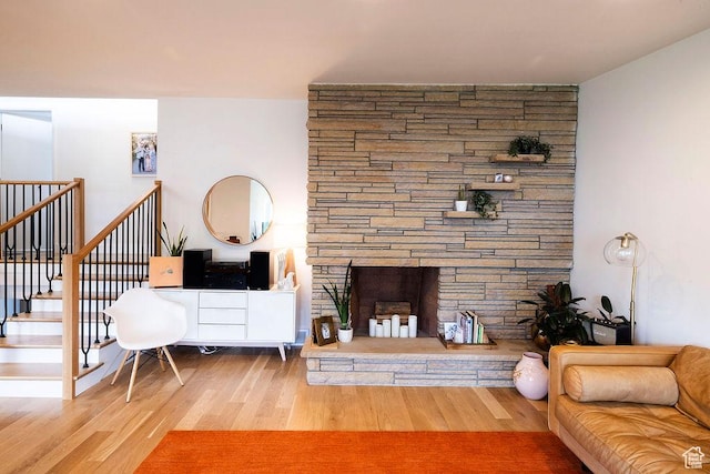 5466 S Woodcrest Dr, Holladay, UT 84117 - living area featuring a stone fireplace, wood finished floors, and stairway