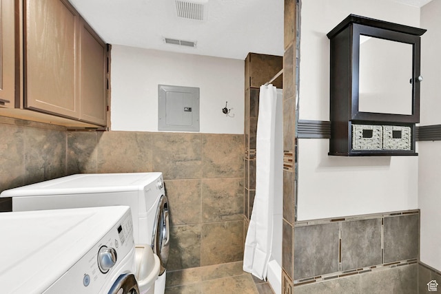 1240 N 2525 W, Layton, UT 84041 - laundry room with washer and clothes dryer, tile walls, electric panel, a wainscoted wall, and cabinet space