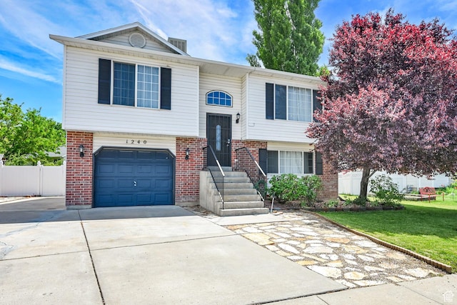 1240 N 2525 W, Layton, UT 84041 - raised ranch with brick siding, a garage, and concrete driveway