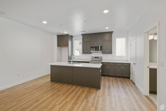 937 W Coalburn Way Unit 102, Murray, UT 84123 - kitchen with stainless steel appliances, a sink, light wood-style flooring, light countertops, and baseboards