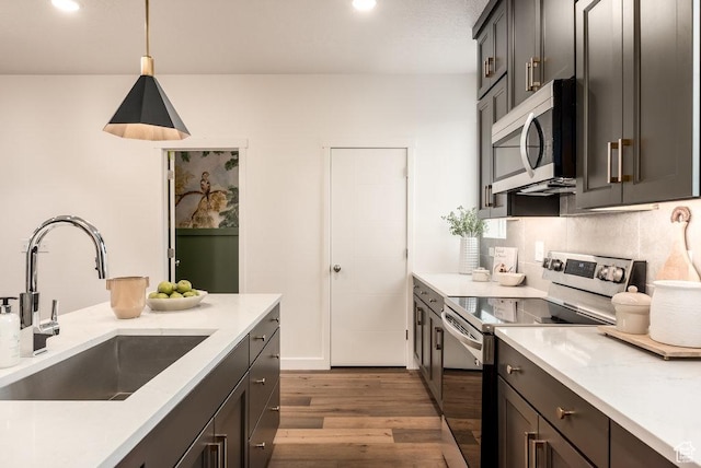 937 W Coalburn Way Unit 102, Murray, UT 84123 - kitchen featuring appliances with stainless steel finishes, a sink, wood finished floors, hanging light fixtures, and recessed lighting