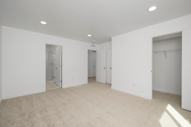 937 W Coalburn Way Unit 102, Murray, UT 84123 - unfurnished bedroom featuring light colored carpet, recessed lighting, a spacious closet, baseboards, and ensuite bathroom