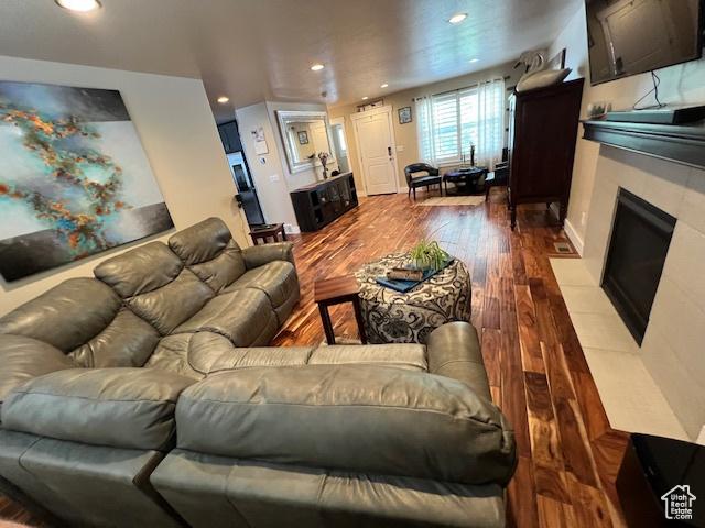 115 E 8469 S, Sandy, UT 84070 - living room with dark wood-style floors, recessed lighting, and a fireplace