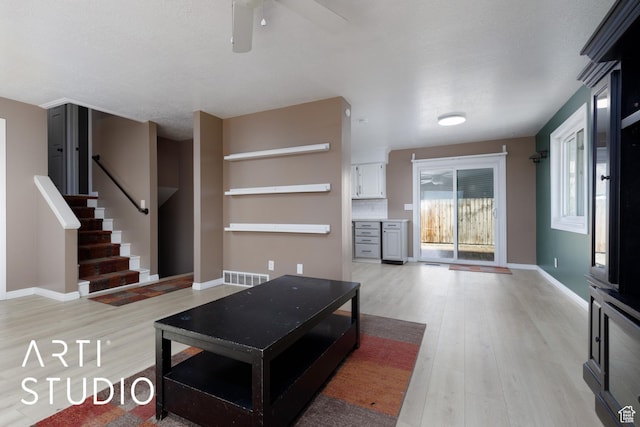 1280 N Gramercy Ave, Ogden, UT 84404 - living area featuring light wood-style flooring, ceiling fan, stairway, and baseboards