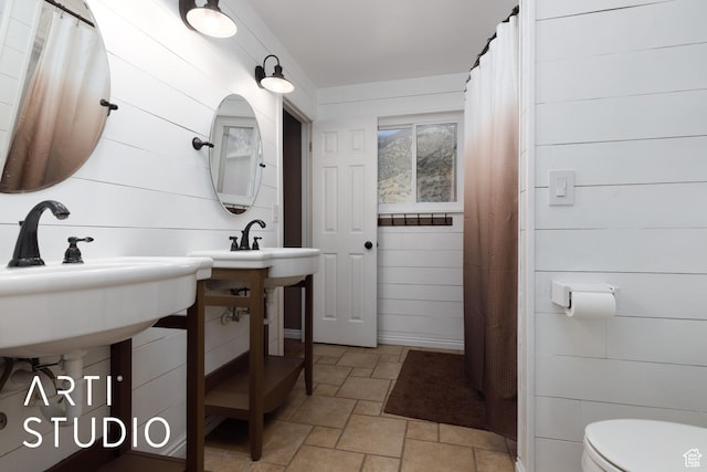 1280 N Gramercy Ave, Ogden, UT 84404 - full bath featuring stone finish flooring, toilet, and wood walls