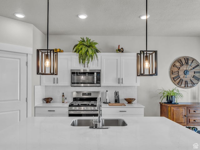 1136 W 1810 S, Orem, UT 84058 - kitchen featuring stainless steel appliances, a sink, tasteful backsplash, white cabinetry, and pendant lighting