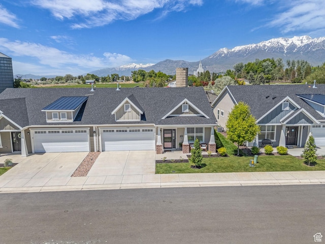 1136 W 1810 S, Orem, UT 84058 - view of front of home featuring a mountain view, concrete driveway, a chimney, a front yard, and a garage