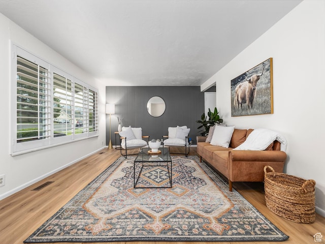 686 Idaho Ave, Provo, UT 84606 - living area with an accent wall, wood finished floors, and baseboards