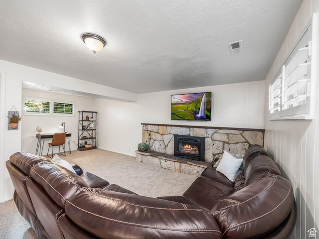 686 Idaho Ave, Provo, UT 84606 - living room with carpet floors, a stone fireplace, and a textured ceiling