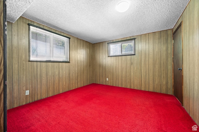 3279 W Crestfield, West Valley City, UT 84119 - empty room featuring a textured ceiling, wood walls, and carpet floors